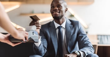 After researching if he should use a credit card for everything, a man uses his credit card to pay for gasoline.