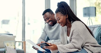 After researching how to get the best mortgage rates in Florida, a couple walks across the lawn of their new house in Gainesville.