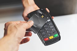 Radiant credit card being used as contactless payment