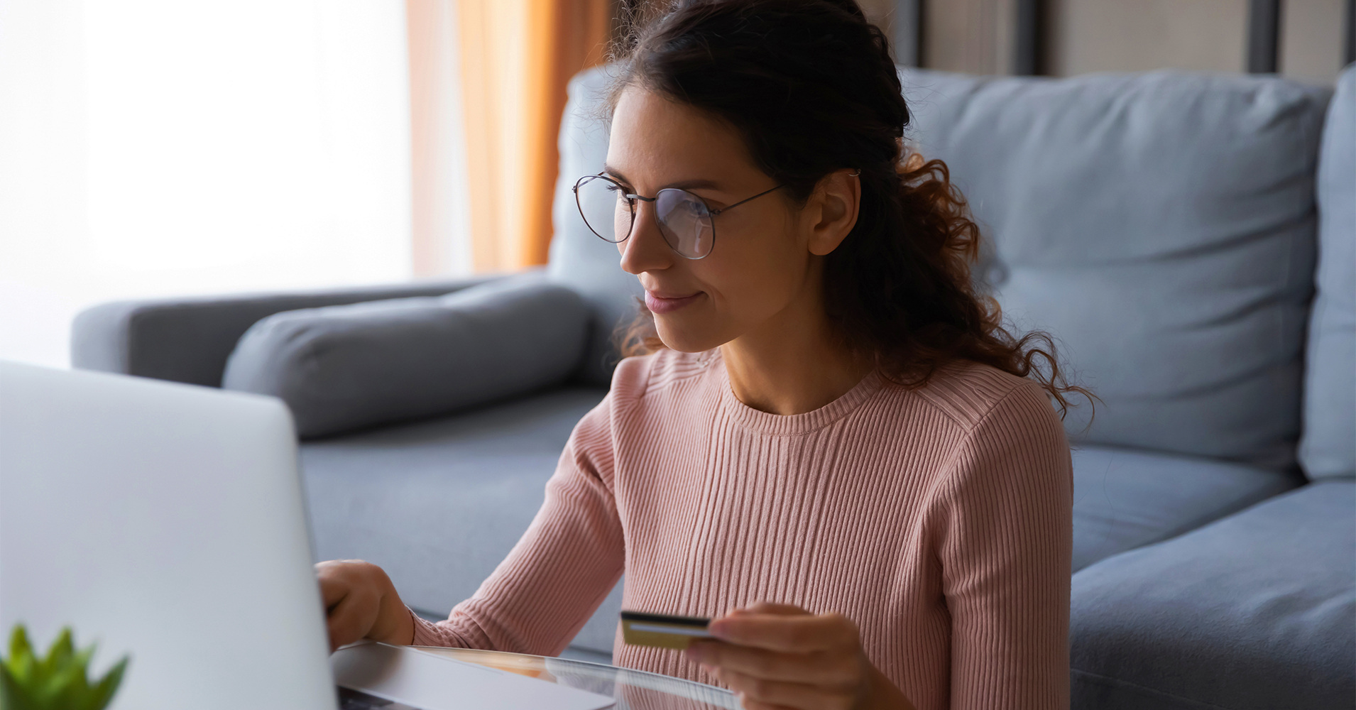 A person stressing over their looming credit card debt while looking online to see how to transfer their credit card balance.